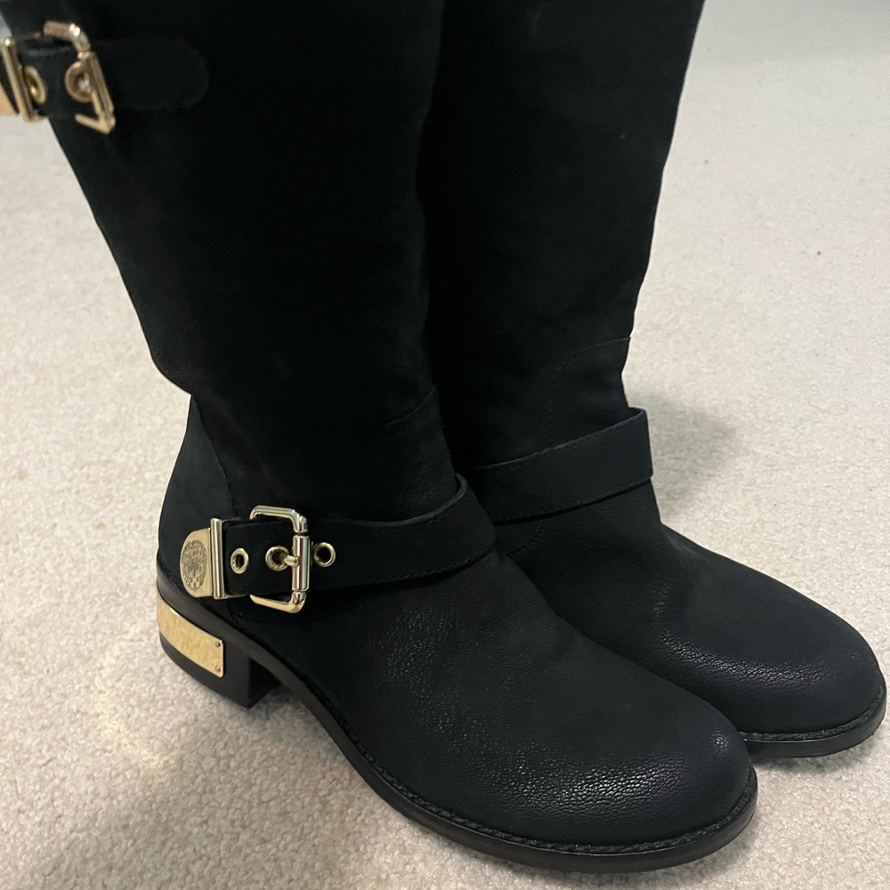 Black boots with gold buckles